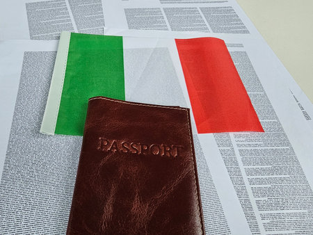 Italian flag and passport placed on newspaper highlighting travel and explorationの写真素材