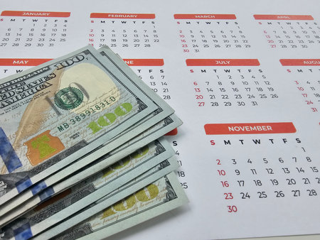 Calendar with cash showing money management for budgeting throughout the yearの写真素材