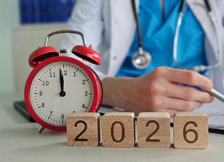 Clock shows time as a doctor prepares notes for future medical appointments in 2026の写真素材