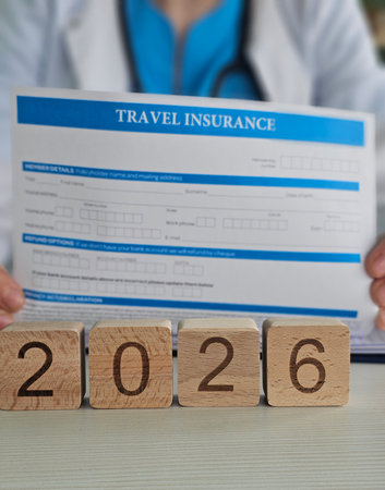 Travel insurance form and wooden blocks showing the year 2026 during a consultation