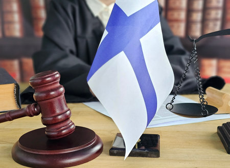 Court session in Finland with gavel, flag, and scales of justice displayed on the benchの写真素材