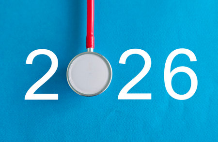 Stethoscope positioned on bright blue background with the number 2026 highlighted for medical themes and future healthcareの写真素材