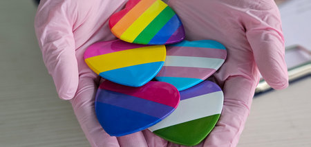 LGBT pride month or LGBTQ and health concept. Doctor with rainbow and colorful heart shape with for Lesbian, Gay, Bisexual, Transgender, Queer and Pansexual communityの写真素材