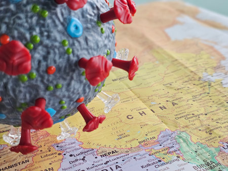 Representation of a virus model over an Asia map highlighting the impact on global health and travel during the pandemicの写真素材
