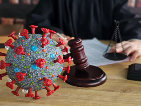 Courtroom scene with a judge and a model of a virus symbolizing legal issues related to health crisesの写真素材