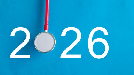 Medical equipment and numbers displayed on vibrant blue background suggesting a new healthcare initiative in 2026の写真素材