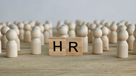 HR concepts illustrated with wooden figures representing people and blocks showing letters in a minimalistic settingの写真素材