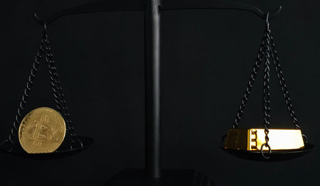 Balancing bitcoin and gold on a scale to represent value comparison in modern financeの写真素材