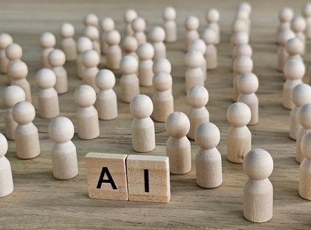 Group of wooden figures gathering around blocks that spell AI on wooden surface representing artificial intelligenceの写真素材