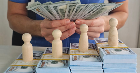 Figures counting money on stacks of cash representing financial growth and management strategies...