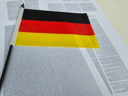 German flag placed on top of printed text in a display language showing or informationの写真素材