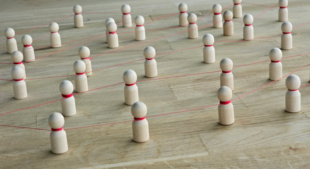 Figures connected with strings on a wooden surface in a creative arrangement inside a room