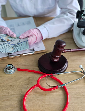 Corruption in forensic medicine. Doctor, money, judicial hammer. Cost of forensic medical examinationsの写真素材