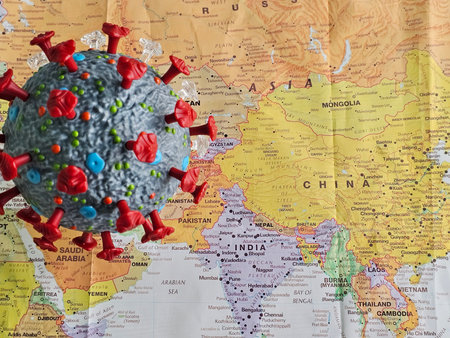Covid virus model placed on a map showing Asia and surrounding countries during the pandemic