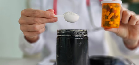 Healthcare professional preparing medication using a spoon and container for patient careの写真素材