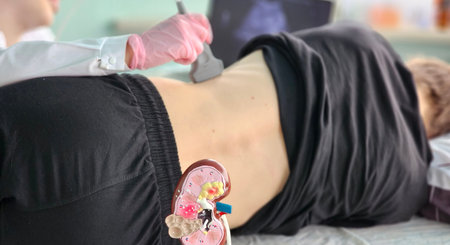 Health professional performing a kidney ultrasound on a patient in a medical facility during a routine checkupの写真素材