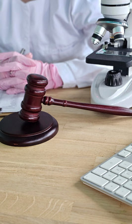 Lab worker conducts research on legal cases using tools like a microscope and gavel with a keyboard...