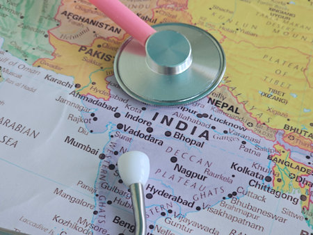 Stethoscope and earbuds on a map of India showing different cities and regions for health and care analysisの写真素材