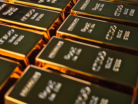 Gold bars stacked in a secure vault, showing shining metal and clear markings in a financial district setting