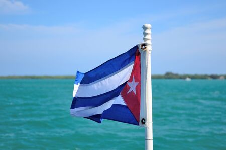 The flag of Cuba with  turquoise sea background.の写真素材