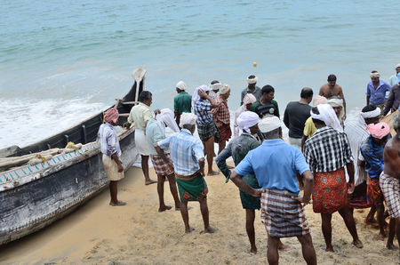 Fishermen near the boat on the beach of Kovalama India.のeditorial素材