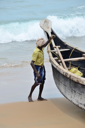 Fishermen near the boat on the beach of Kovalama India.のeditorial素材