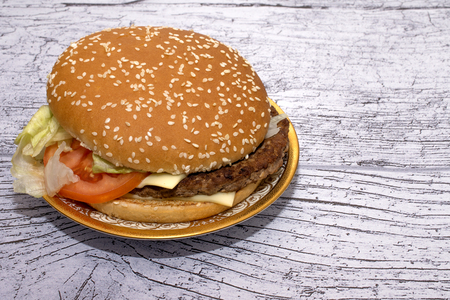 burger with salad in a beautiful plate on a wooden tableの写真素材