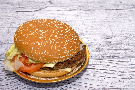burger with salad in a beautiful plate on a wooden tableの写真素材
