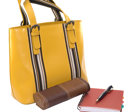 lady's bag, a case of glasses, notebook and pen isolated on white backgroundの写真素材