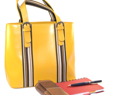 lady's bag, a case of glasses, notebook and pen isolated on white backgroundの写真素材