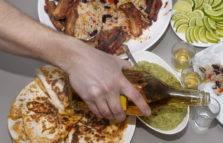 Mexican party. tequila and traditional Mexican dishes on the tableの写真素材