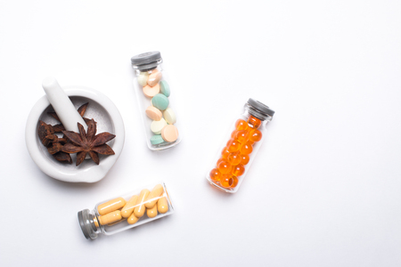 Vitamins, omega 3, cod-liver oil, dietary supplement and tablets an embankment on a light background close up, the top viewの写真素材