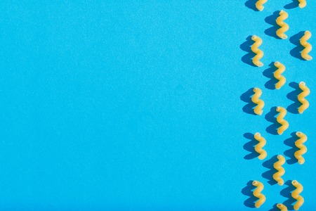 Pasta closeup on a blue background. View from above.