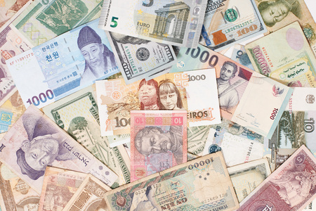 many different currencies as colorful background concept global money