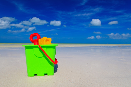 kids toys on white sand beach, playing on vacationの写真素材