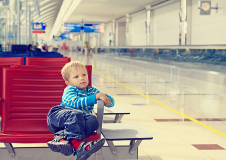 little boy waiting in the airport, kid travelの写真素材
