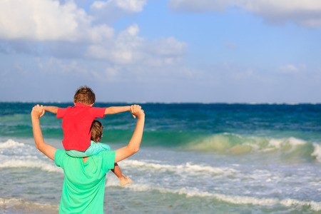 happy father and son playing on sea vacationの写真素材