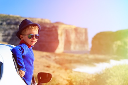 happy little boy travel by car on summer vacation, kids travelの写真素材
