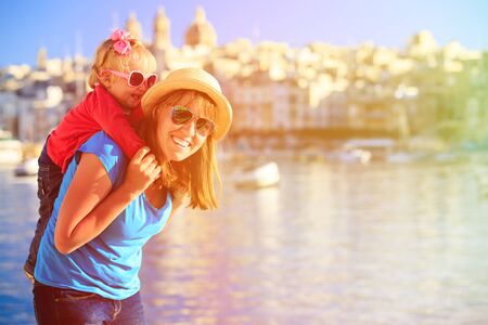 mother and daughter playing on the quay of  Valetta, Maltaの写真素材