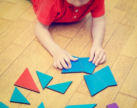 little boy playing with puzzle, early education concept