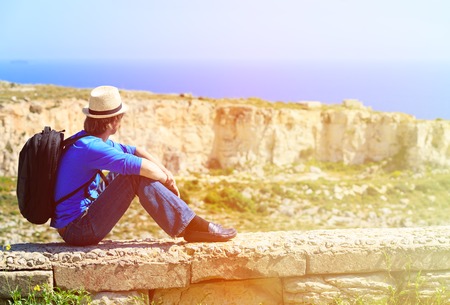 young tourist hiking in scenic mountains, travel conceptの写真素材