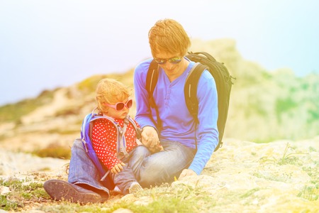 father and little daughter hiking in mountains, family travelの写真素材