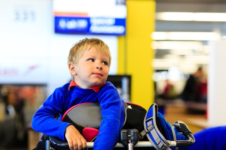 little boy waiting in the airport, child travelの写真素材
