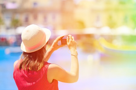 tourist making photo of colorful traditional boats in Marsaxlokk, Maltaの写真素材