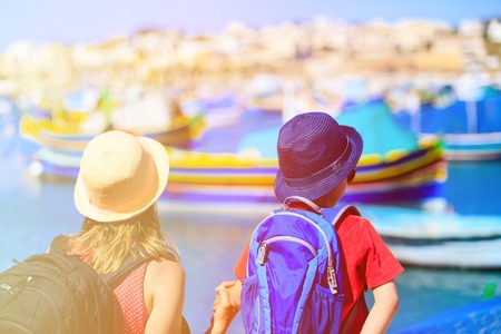 mother and son looking at traditional boats in Malta, family travelの写真素材