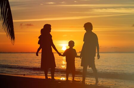 happy family with two kids on sunset tropical beachの写真素材
