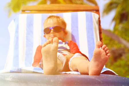 feet of child relaxed and enjoying summer beach vacationの写真素材