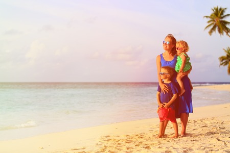 happy mother with two kids at tropical beach, family vacationの写真素材