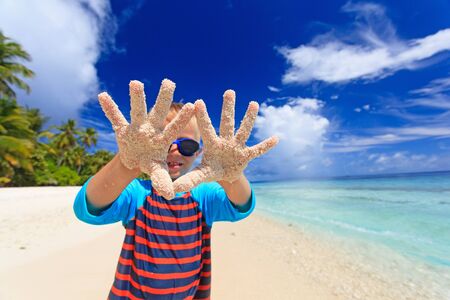 little boy having fun on tropical beach vacationの写真素材