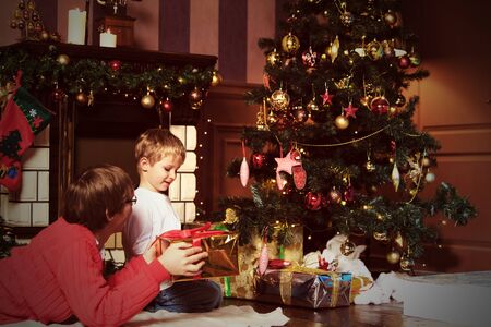 father and son giving presents on Christmas at homeの写真素材